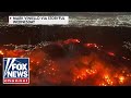 'LIKE MORDOR': Airline passenger captures stunning wildfire images